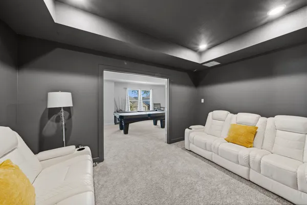 a bedroom with a bed couch and window