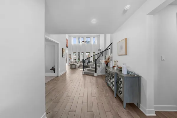 a view of entryway and hall with wooden floor