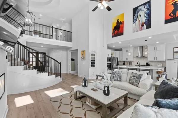 a living room with furniture kitchen view and a table