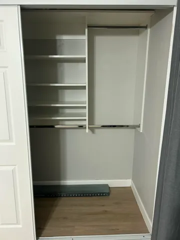 a view of a room with wooden floor