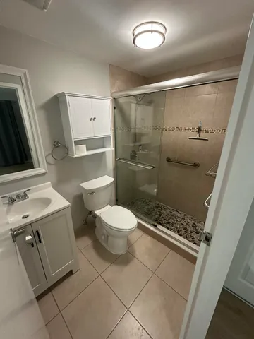 a bathroom with a toilet a sink and a shower