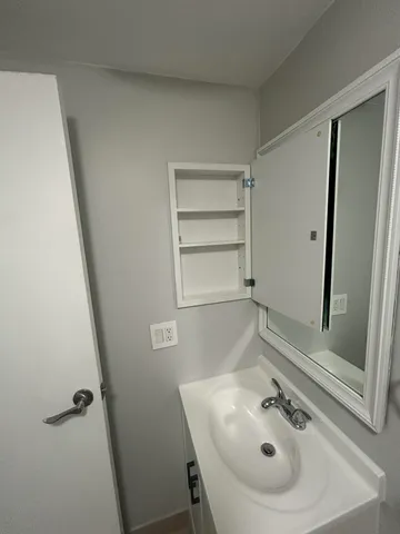 a bathroom with a sink and mirror