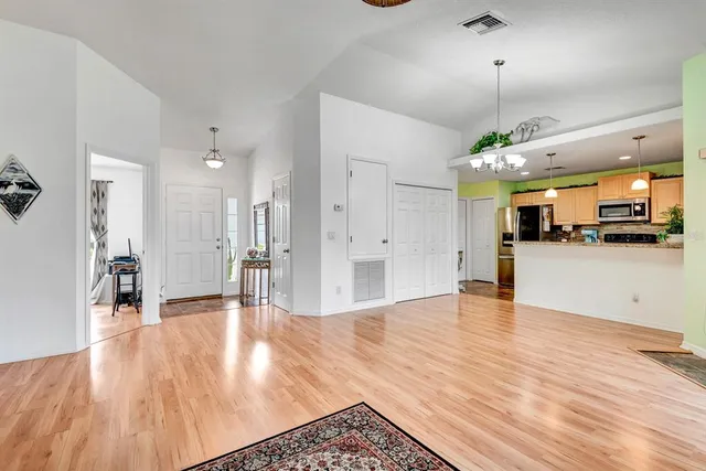a view of a kitchen with furniture and wooden floor