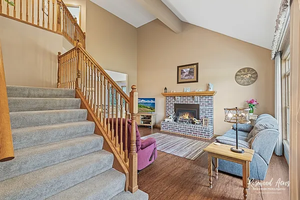 a view of a livingroom with furniture a fireplace chandeliers fan