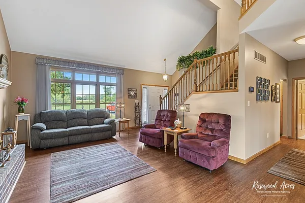 a living room with furniture windows and wooden floor