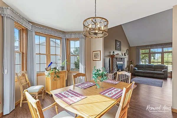 a view of a dining room with furniture wooden floor and chandelier