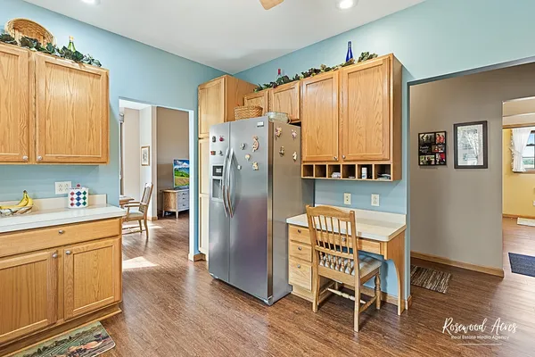 a kitchen with stainless steel appliances a refrigerator and wooden cabinets