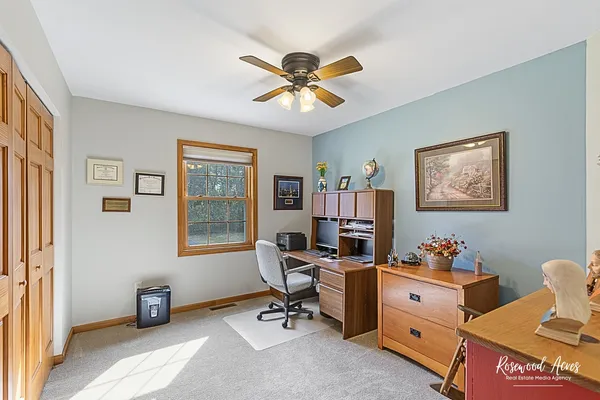 a workspace with chandelier fan and a window