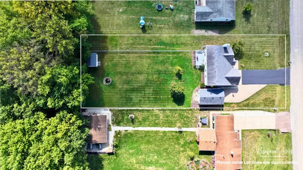 an aerial view of residential houses with outdoor space and street view