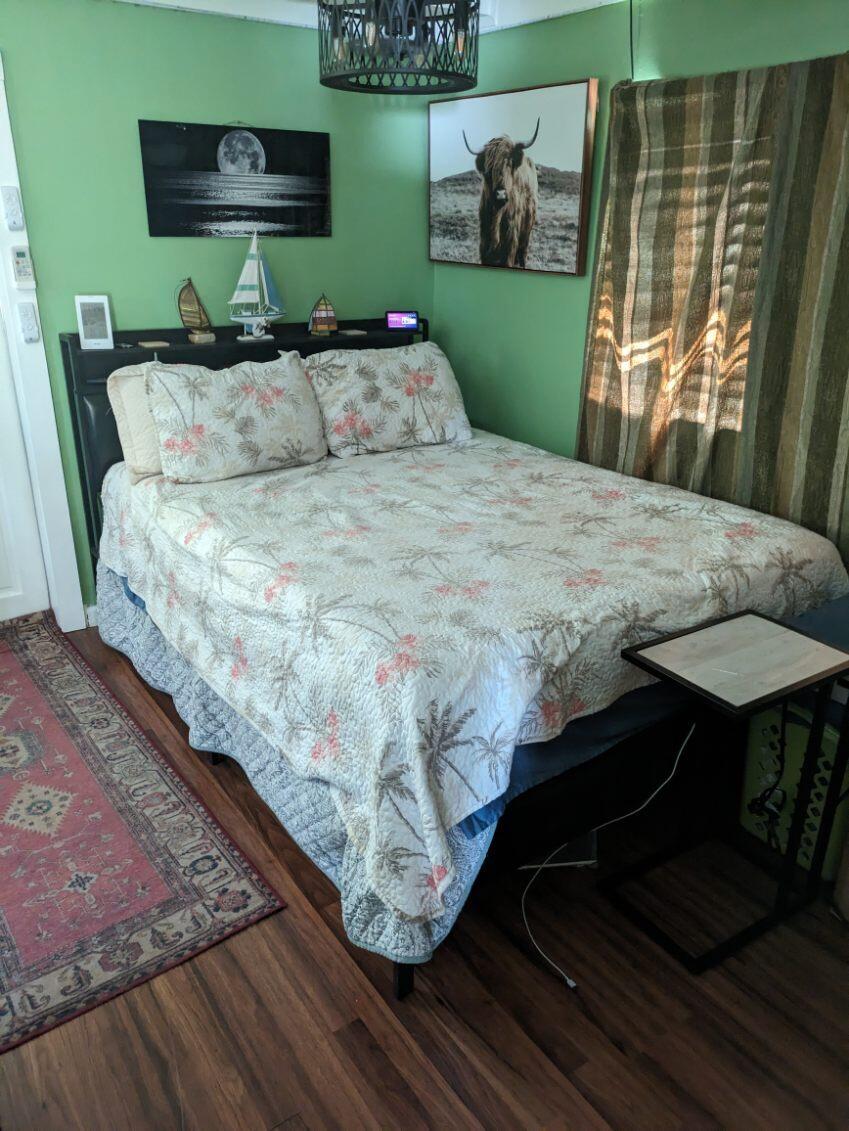 1703 Johnson Street, Unit B Key West, FL 33040 - Photo 2 of 10 a bedroom with a bed window and a flat screen tv