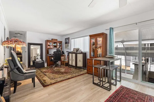 a living room with furniture a flat screen tv and a table