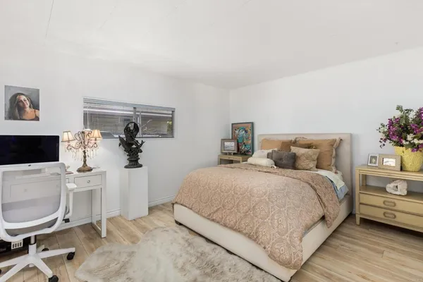 a bedroom with a bed a table and chair