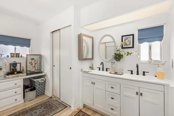 a bathroom with a double vanity sink and a mirror