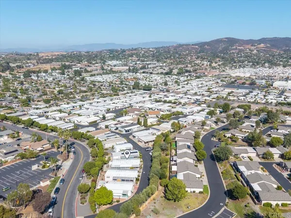 a front view of a house with a yard outdoor seating and a pathway
