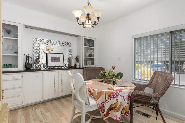a dining room with furniture a livingroom and chandelier
