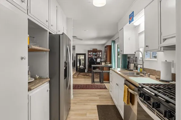 a kitchen with stainless steel appliances granite countertop a stove and a refrigerator