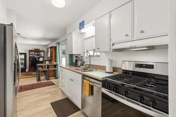 a kitchen with stainless steel appliances granite countertop a stove and a refrigerator