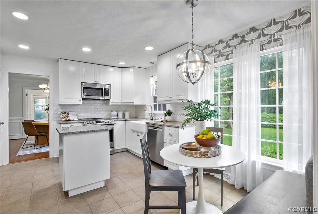 2301 Winterfield Road Midlothian, VA 23113 - Photo 22 of 50 a kitchen with a table chairs and microwave