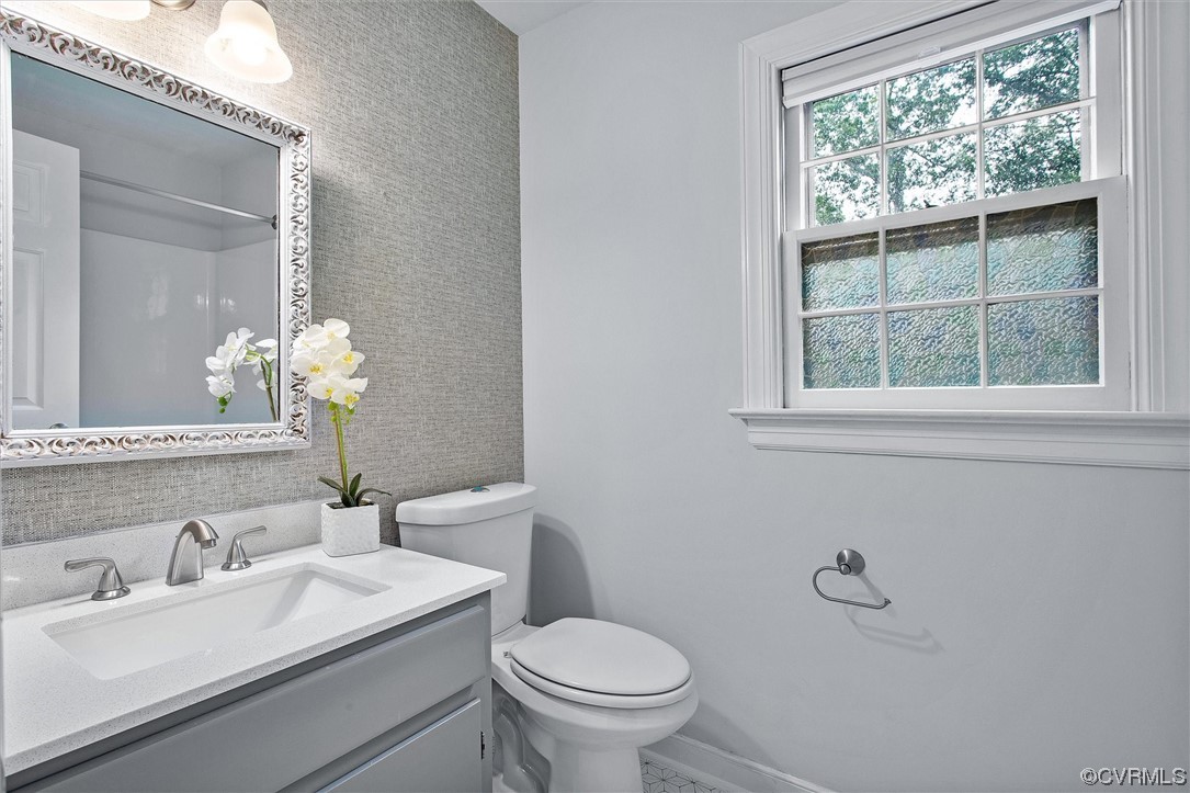 2301 Winterfield Road Midlothian, VA 23113 - Photo 42 of 50 a bathroom with a granite countertop toilet a sink a mirror and a window