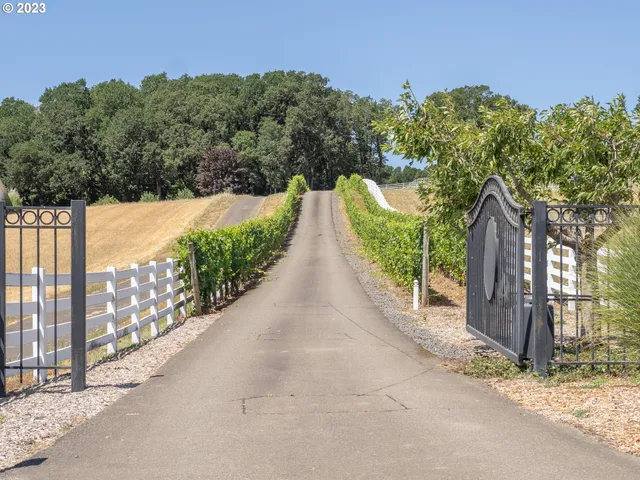 a view of a pathway with a wrought fence