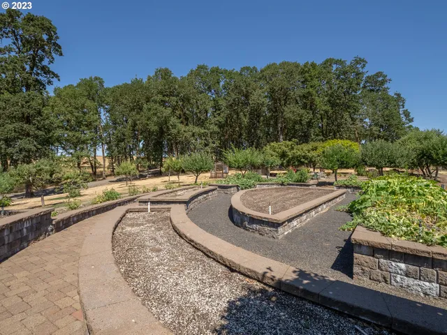 a view of backyard with table and chairs under an umbrella