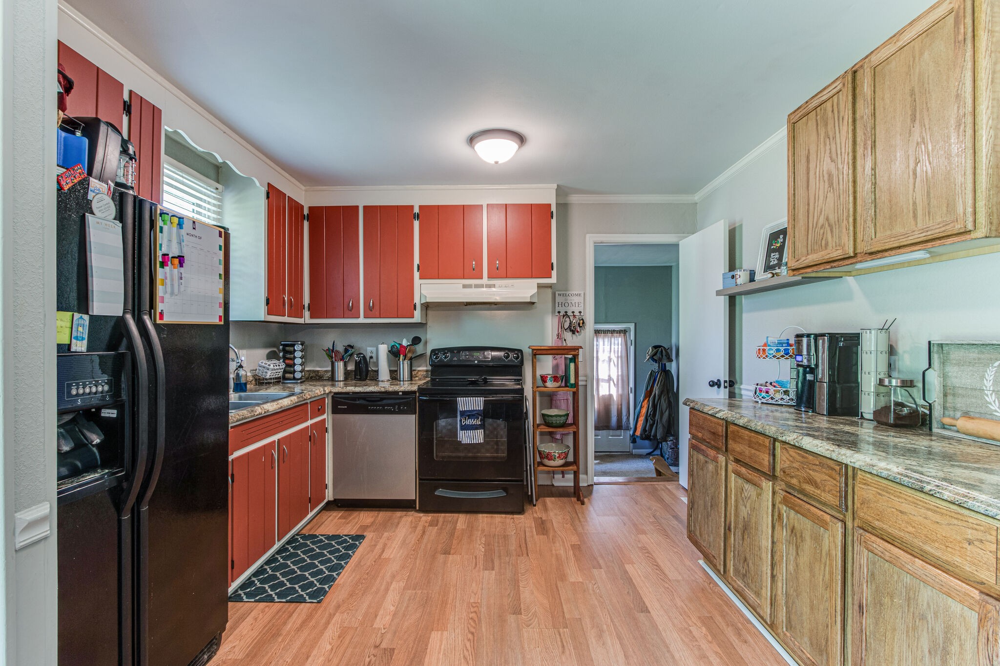 2234 South Ranch Road Murfreesboro, TN 37129 - Photo 11 of 29 a kitchen with stainless steel appliances granite countertop refrigerator a stove top oven a sink dishwasher and wooden cabinets with wooden floor