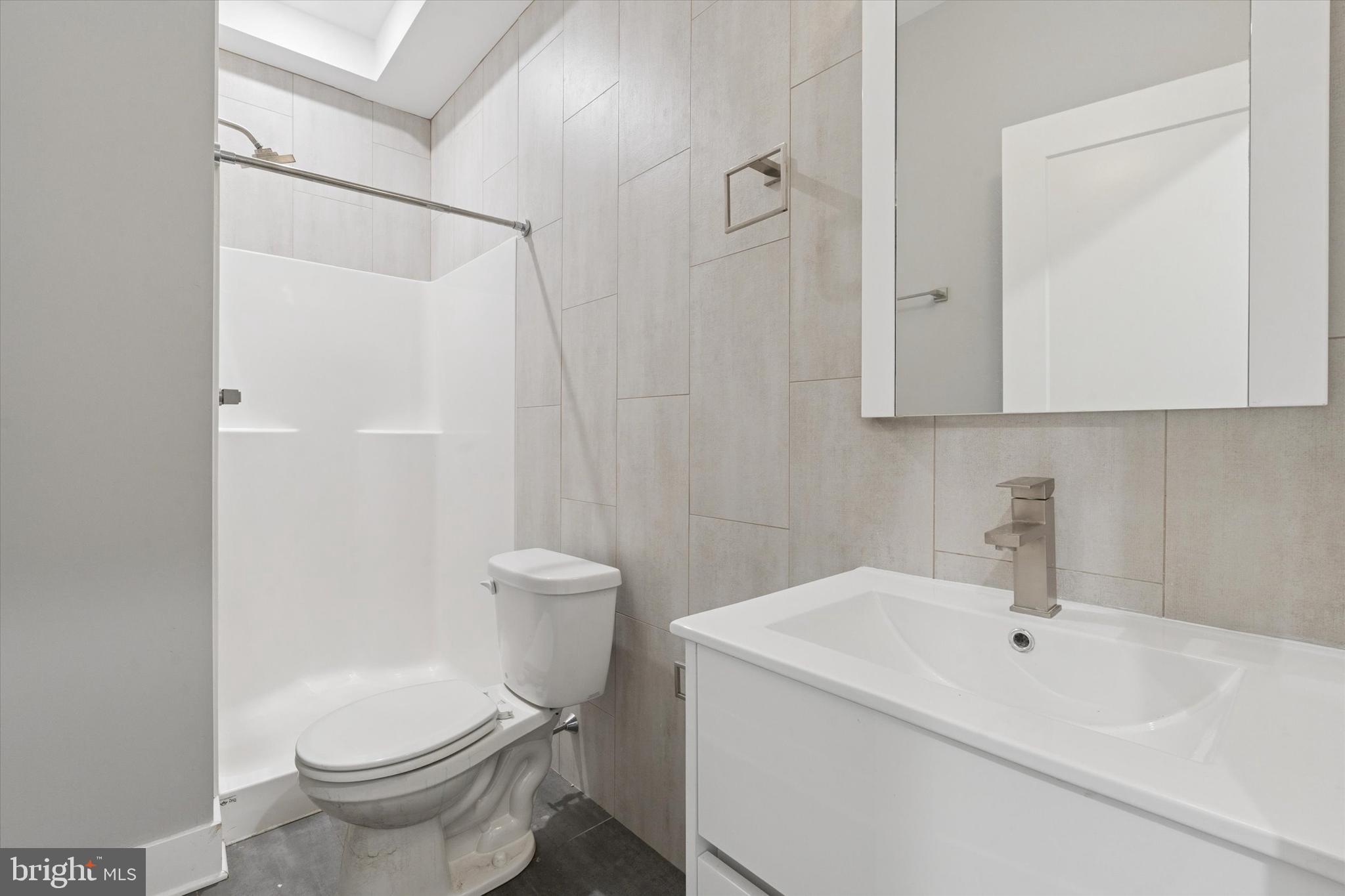 3817 Wallace Street Philadelphia, PA 19104 - Photo 19 of 25 a white toilet sitting next to a bathroom sink