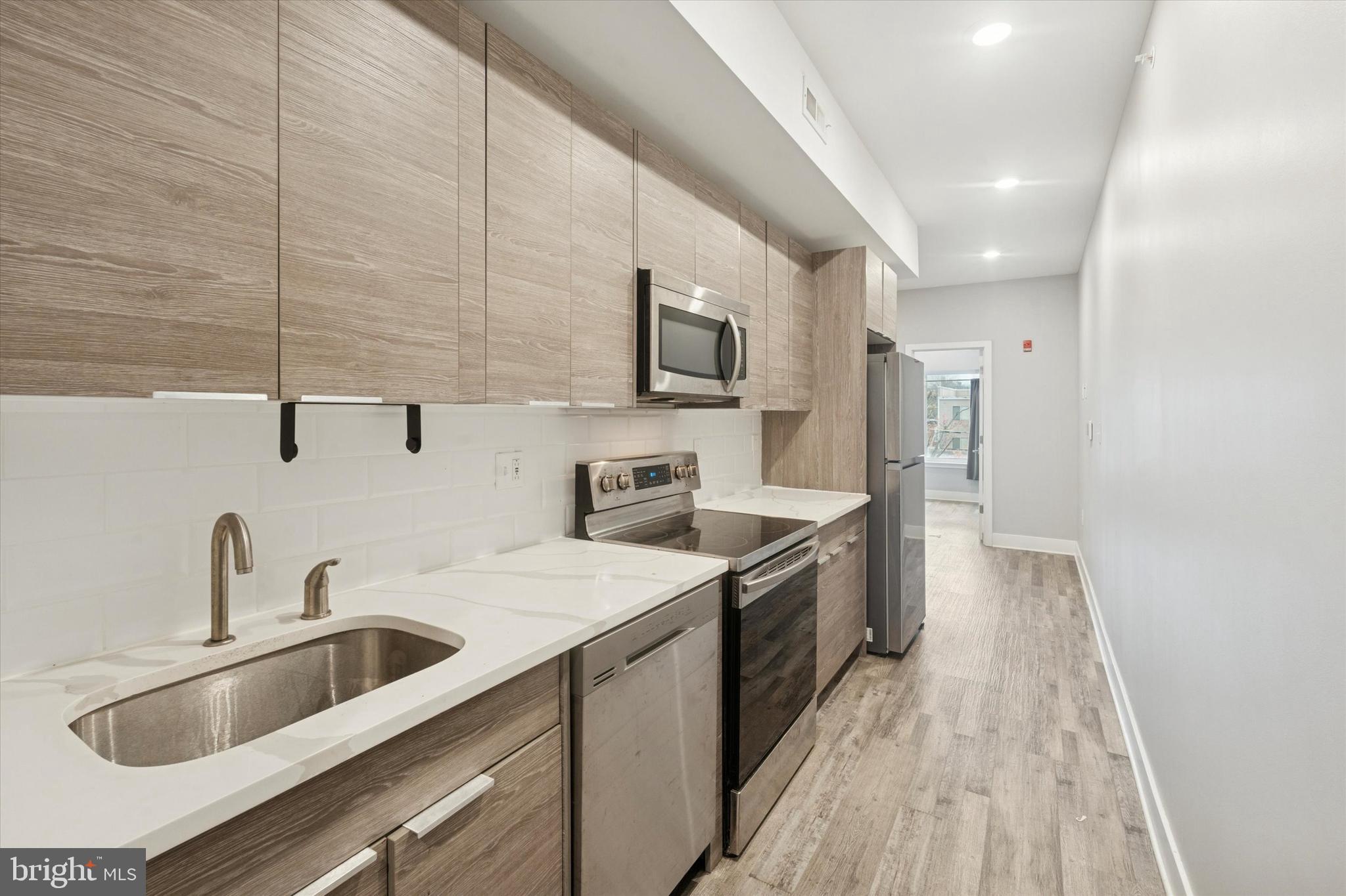 3817 Wallace Street Philadelphia, PA 19104 - Photo 20 of 25 a kitchen with a sink cabinets and stainless steel appliances