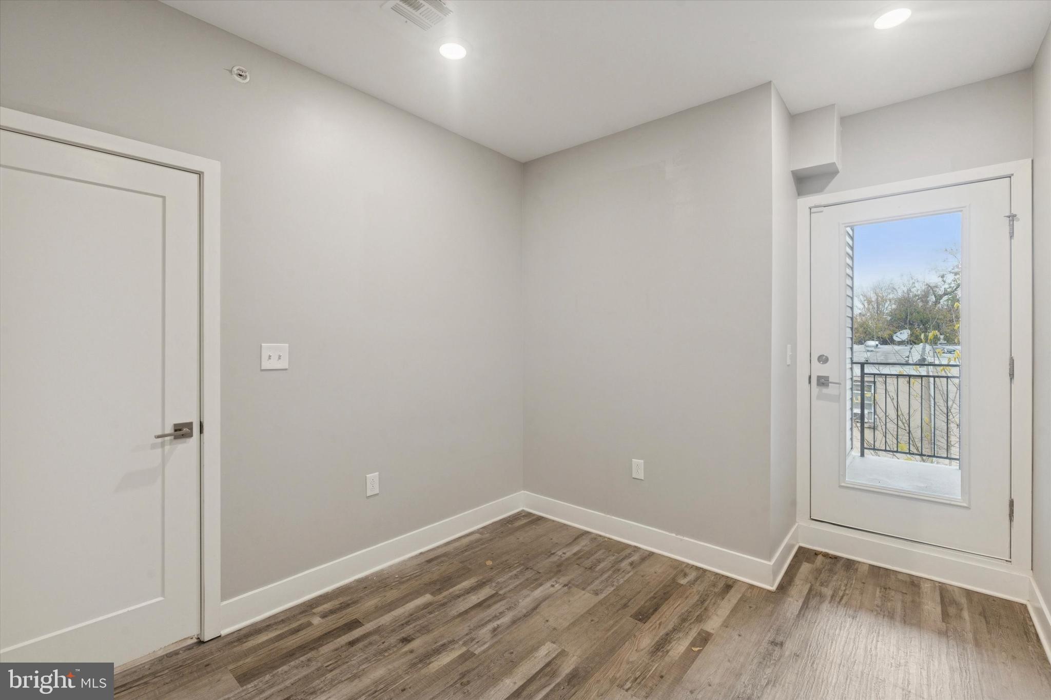 3817 Wallace Street Philadelphia, PA 19104 - Photo 21 of 25 a view of an empty room with wooden floor and a window