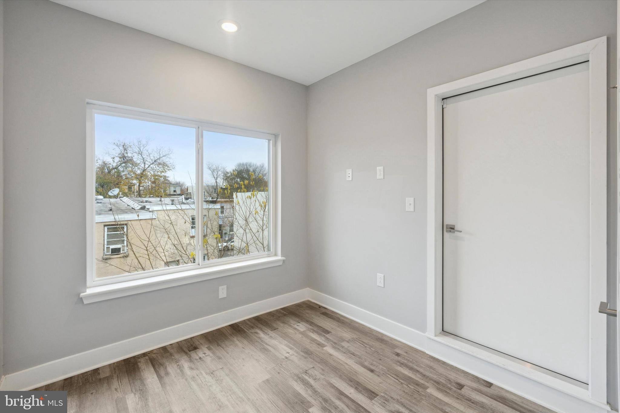 3817 Wallace Street Philadelphia, PA 19104 - Photo 23 of 25 a view of an empty room with wooden floor and a window