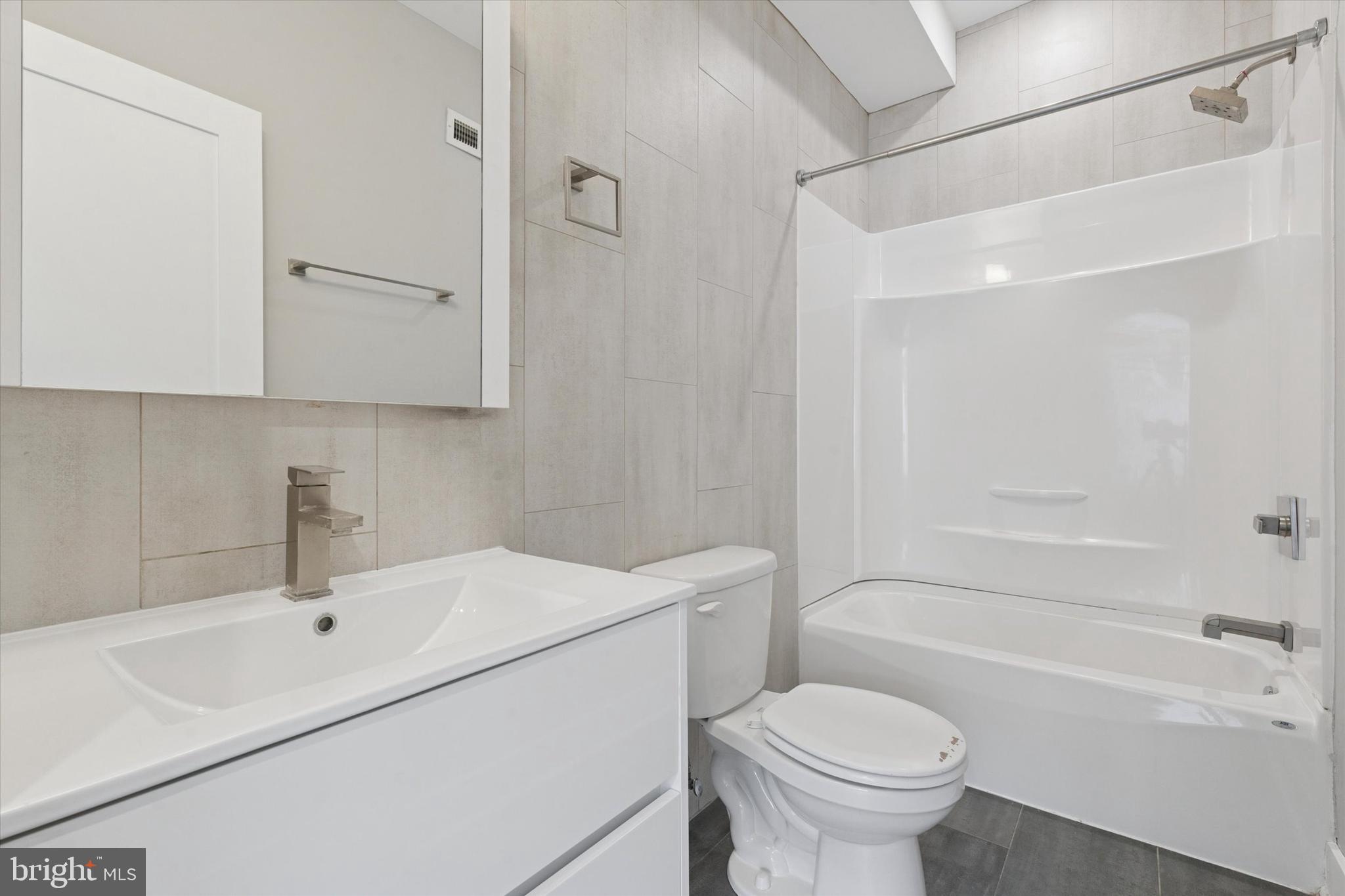 3817 Wallace Street Philadelphia, PA 19104 - Photo 7 of 25 a bathroom with a sink toilet and a bathtub