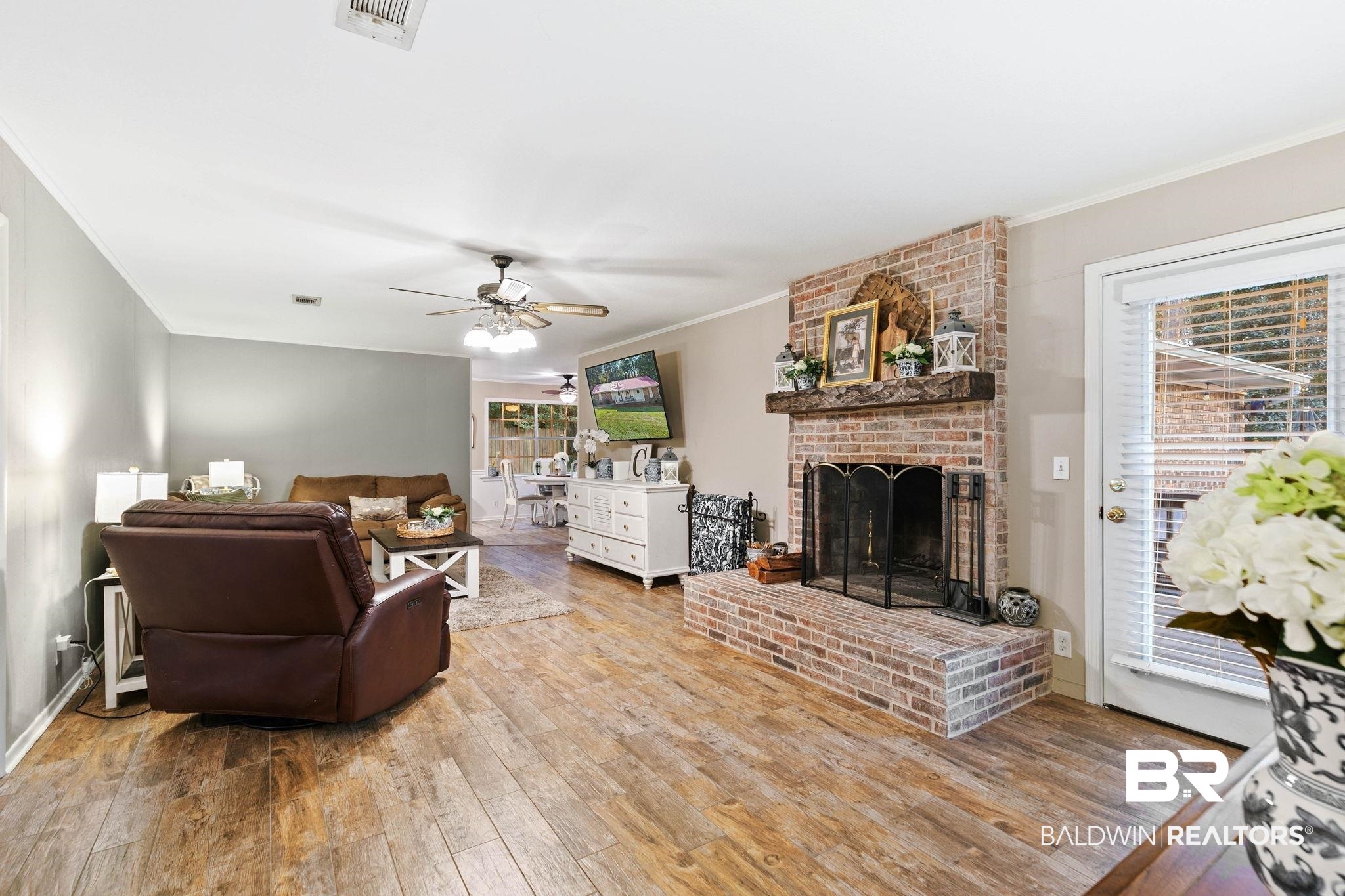 4 Rally Road Spanish Fort, AL 36527 - Photo 11 of 41 Living room with crown molding, a fireplace, hardwood / wood-style flooring, and ceiling fan