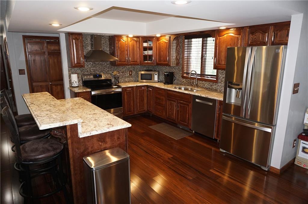 292 Evans Road Zelienople, PA 16063 - Photo 2 of 12 Gorgeous hardwood flooring, granite counter-tops along with stainless steel appliances, highlight the Kitchen.