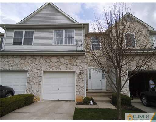 5 Stony Hill Road Jamesburg, NJ 08831 - Photo 1 of 17 a front view of a house with a yard and garage