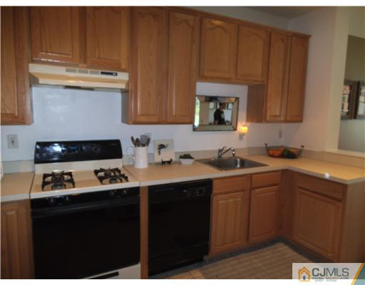 5 Stony Hill Road Jamesburg, NJ 08831 - Photo 2 of 17 a kitchen with stainless steel appliances a sink stove and cabinets