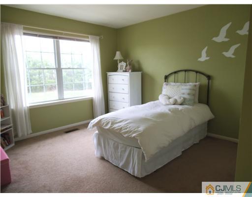 5 Stony Hill Road Jamesburg, NJ 08831 - Photo 12 of 17 a bedroom with a bed and window