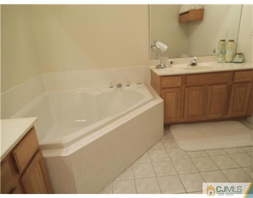 5 Stony Hill Road Jamesburg, NJ 08831 - Photo 14 of 17 a bathroom with a sink a toilet and vanity