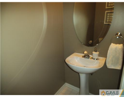 5 Stony Hill Road Jamesburg, NJ 08831 - Photo 16 of 17 a bathroom with a sink and mirror