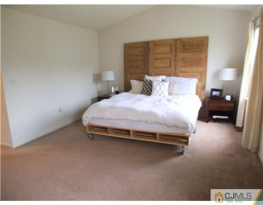 5 Stony Hill Road Jamesburg, NJ 08831 - Photo 10 of 17 a bedroom with a bed and wooden floor
