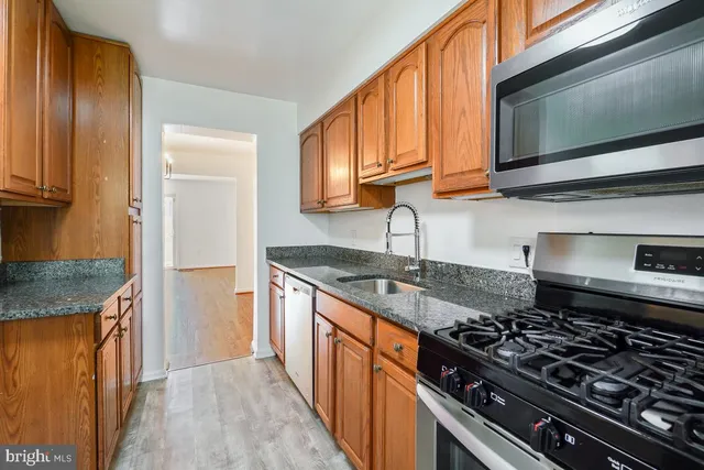a kitchen with stainless steel appliances granite countertop a stove and a sink