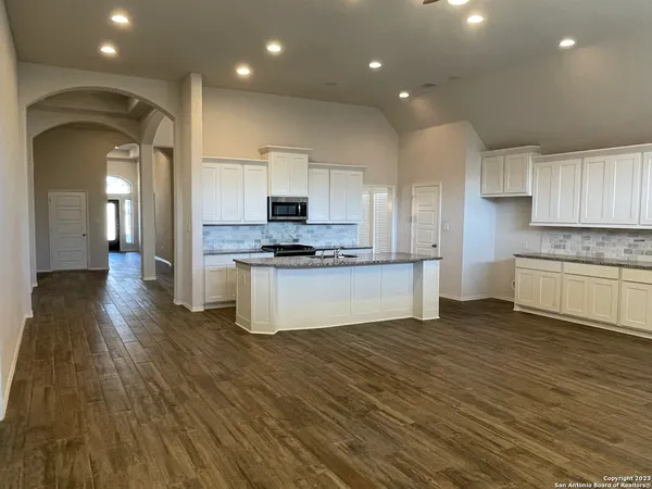 a view of kitchen with cabinets and wooden floor