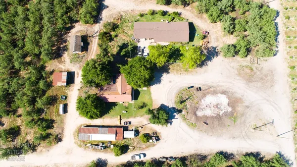 a backyard of a house with table and chairs