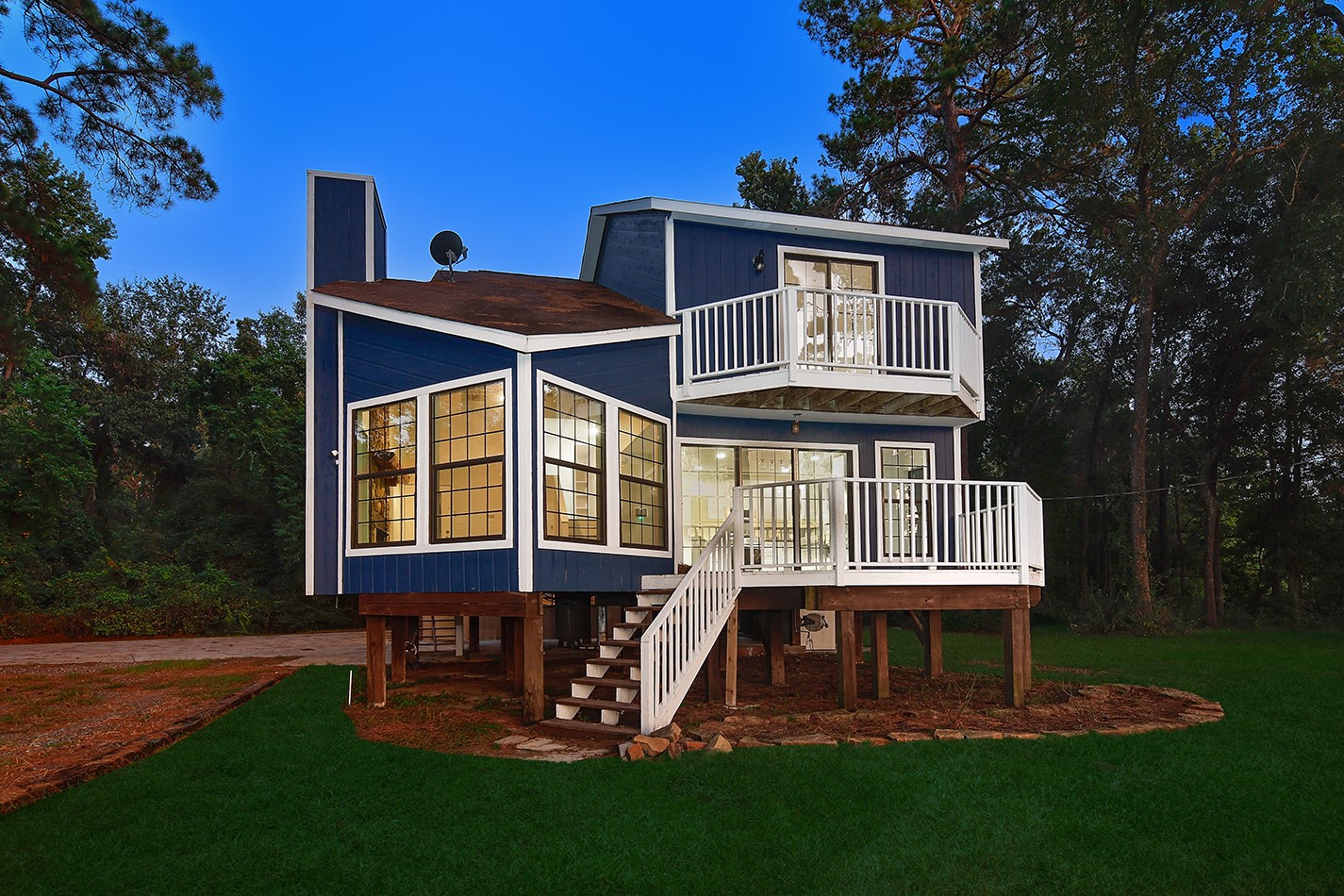a front view of a house with a yard table and chairs