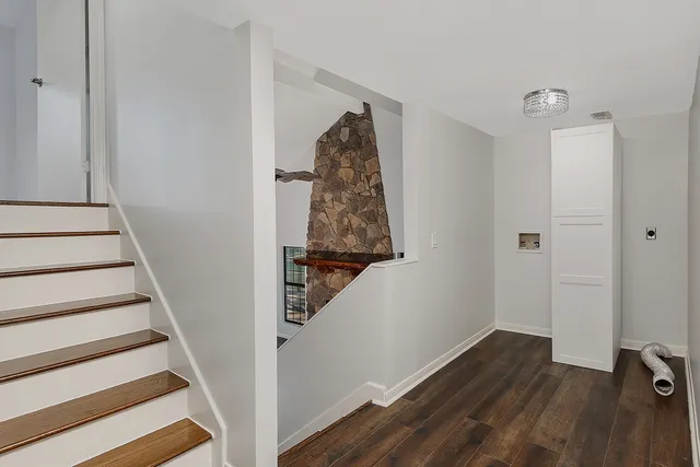 a view of a hallway with wooden floor and entryway