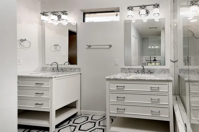 a bathroom with a sink double vanity and a mirror