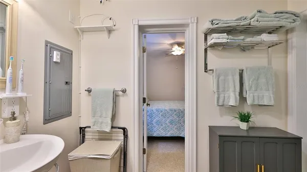 a en suite bathroom with a granite countertop sink and mirror