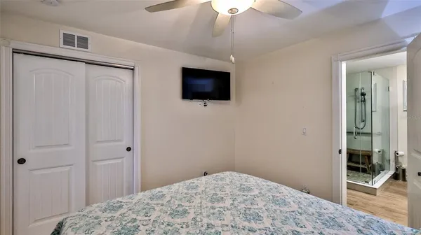 a bedroom with a bed and a flat screen tv