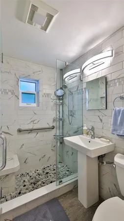 a bathroom with a sink toilet and shower