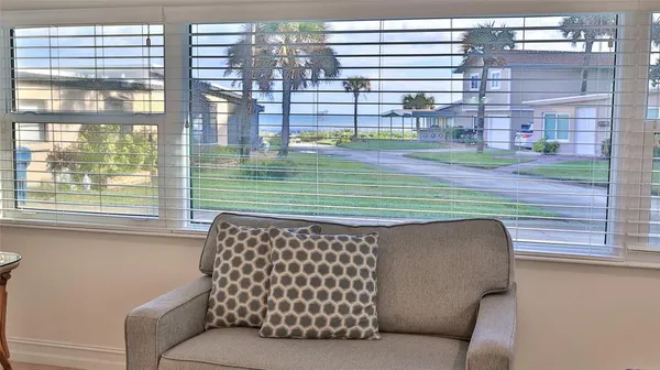 a side view of a chair and table in the balcony