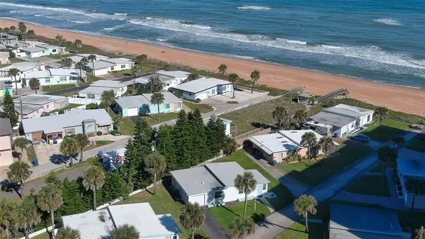 an aerial view of a house with a yard swimming pool and outdoor seating